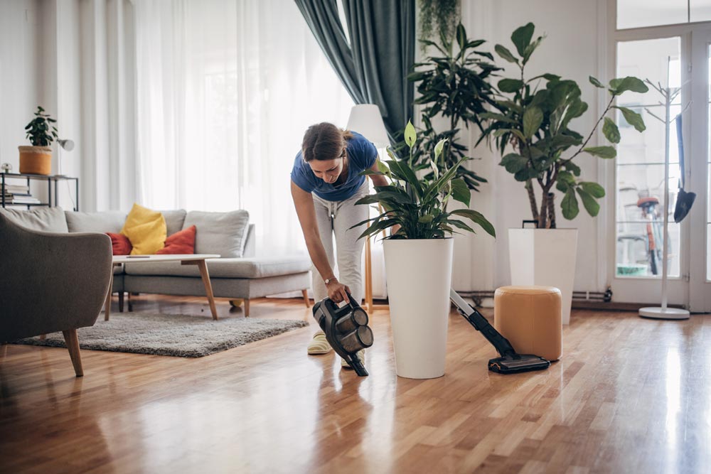 woman using safe hardwood floor cleaning products